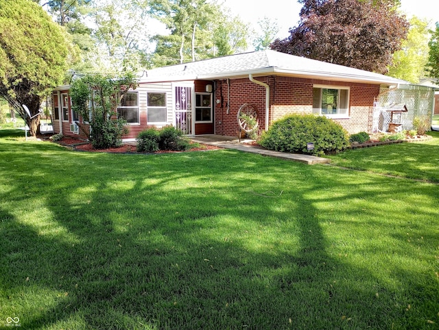 view of front facade with a front lawn and brick siding