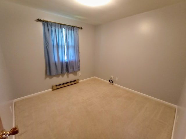 empty room featuring light colored carpet, baseboards, and baseboard heating
