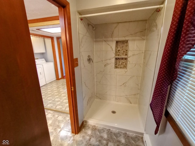 full bath with a shower stall, baseboards, tile patterned floors, and separate washer and dryer