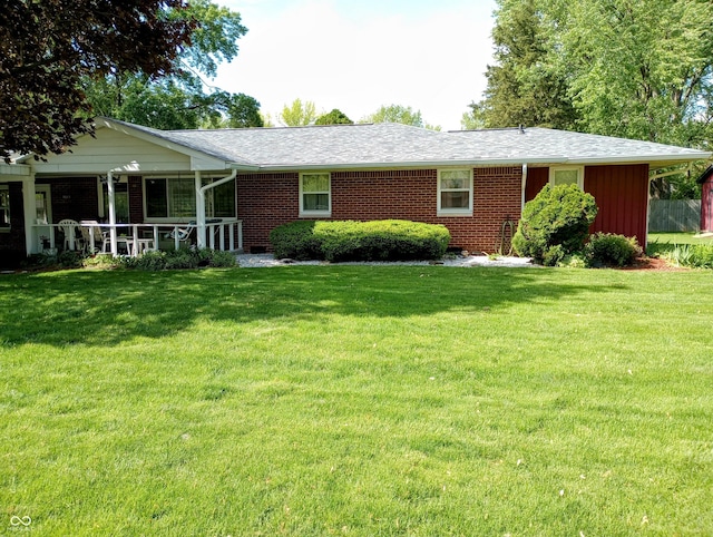 view of front of home featuring a front lawn and brick siding