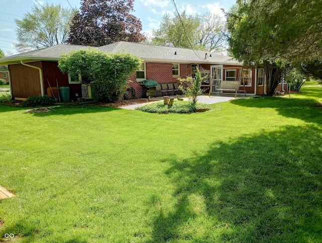 back of property featuring a yard and a patio