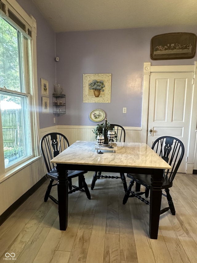 2119 S Garfield Dr, Indianapolis, IN 46203 - dining space with wainscoting, light wood finished floors, and healthy amount of natural light