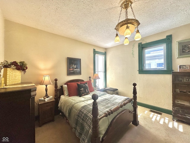 2119 S Garfield Dr, Indianapolis, IN 46203 - carpeted bedroom featuring multiple windows, baseboards, and a textured ceiling