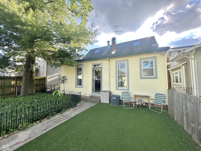 2119 S Garfield Dr, Indianapolis, IN 46203 - rear view of property with a chimney, entry steps, and cooling unit
