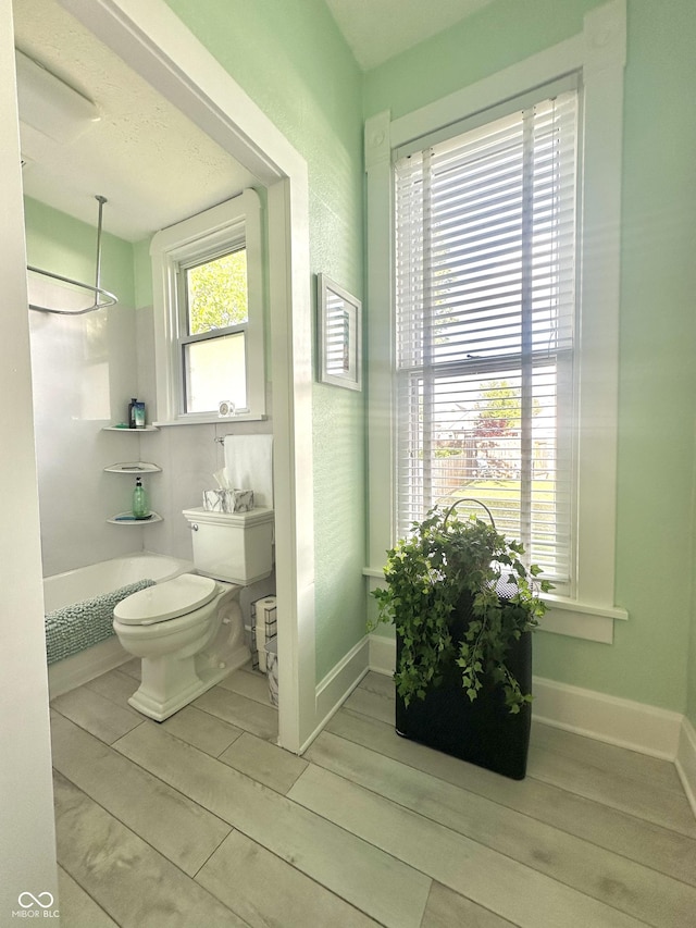 2119 S Garfield Dr, Indianapolis, IN 46203 - full bath with wood finished floors, toilet, and shower / washtub combination
