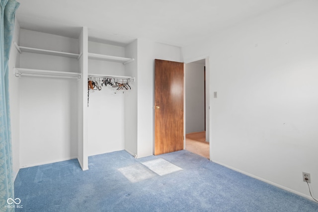 unfurnished bedroom featuring carpet and a closet