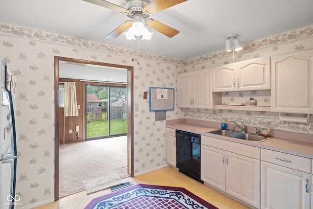 kitchen with visible vents, freestanding refrigerator, black dishwasher, wallpapered walls, and a sink