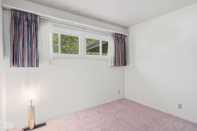 unfurnished room featuring carpet and visible vents