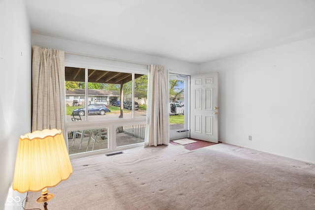 carpeted empty room with visible vents