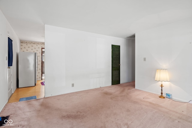 spare room featuring carpet and visible vents