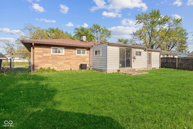 back of house with a lawn, cooling unit, and fence private yard