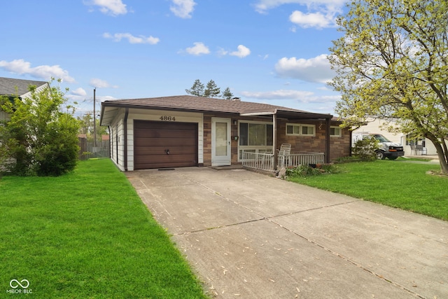 single story home with a porch, a garage, driveway, and a front yard