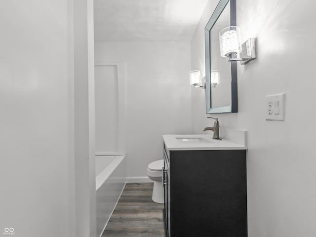 1630 N Granville Ave N, Muncie, IN 47303 - bathroom featuring vanity, wood finished floors, toilet, a washtub, and walk in shower