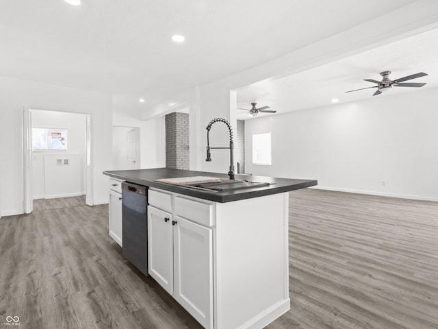 1630 N Granville Ave N, Muncie, IN 47303 - kitchen with white cabinets, dark countertops, a sink, dishwasher, and wood finished floors