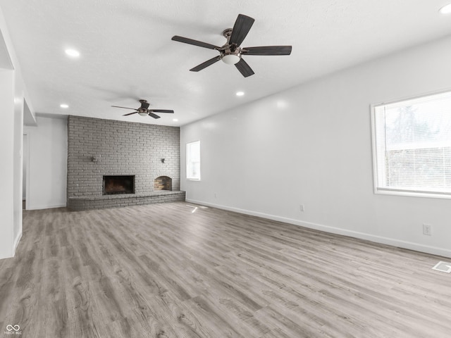 1630 N Granville Ave N, Muncie, IN 47303 - unfurnished living room with recessed lighting, a brick fireplace, and wood finished floors