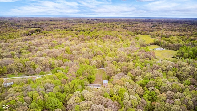 drone / aerial view with a wooded view