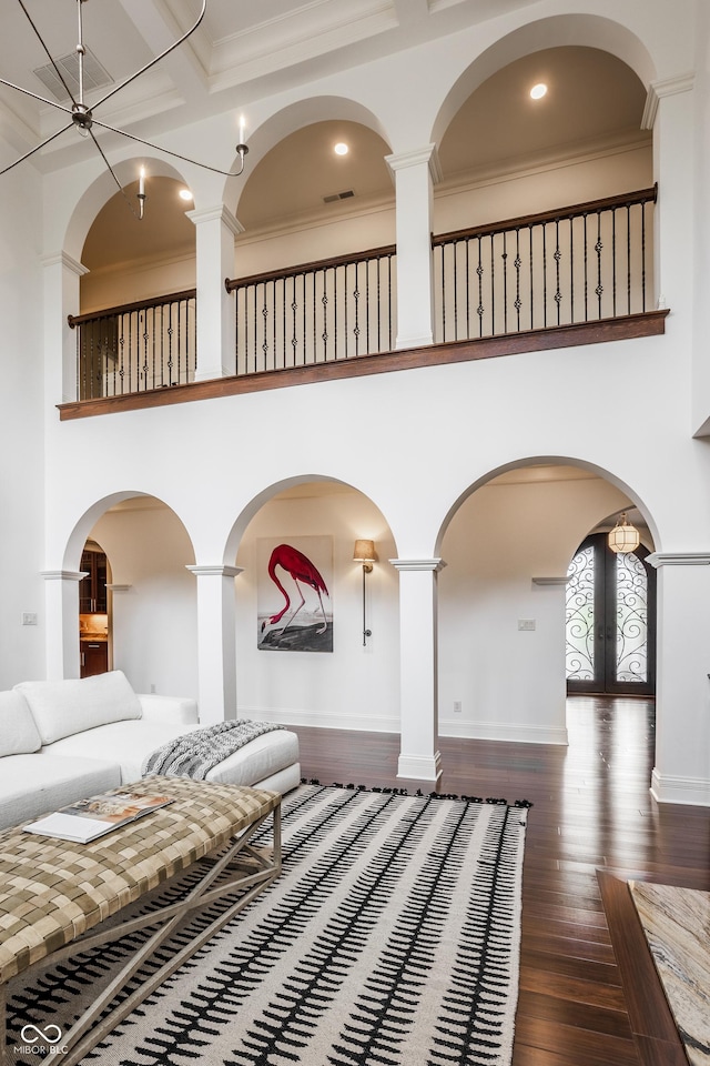 living room featuring crown molding, wood finished floors, a high ceiling, and recessed lighting