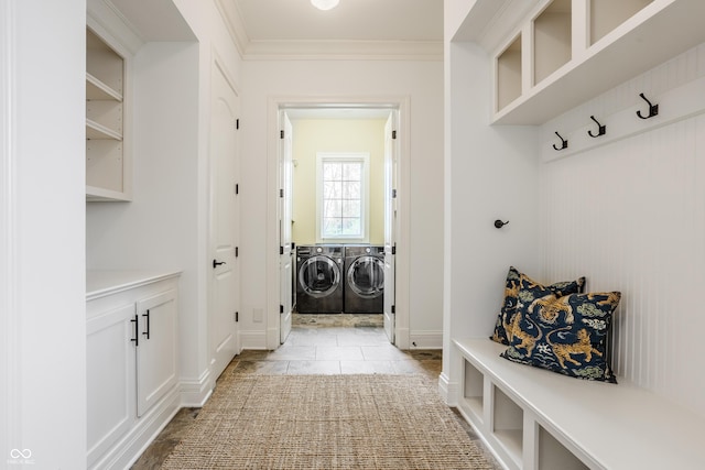 mudroom featuring ornamental molding, washer and dryer, and light tile patterned flooring