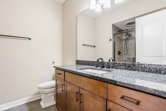 bathroom featuring toilet, vanity, tile patterned flooring, a shower stall, and baseboards