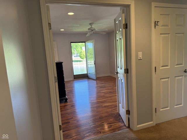 hall featuring baseboards, recessed lighting, and dark wood-style floors