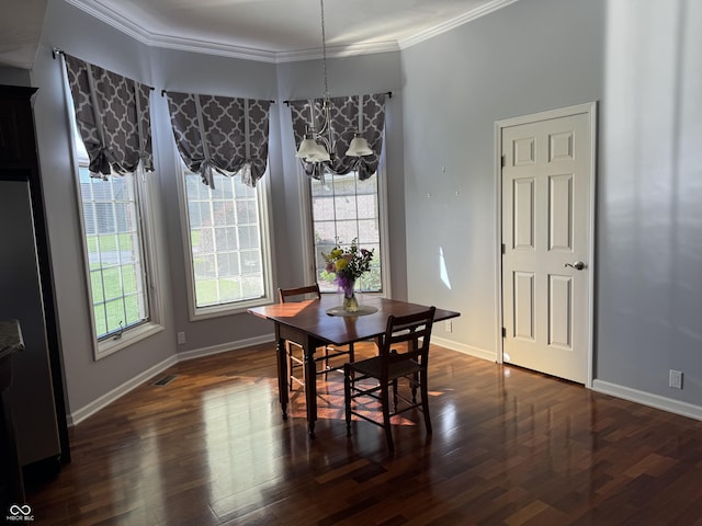 dining room with healthy amount of natural light, crown molding, a chandelier, dark wood finished floors, and baseboards