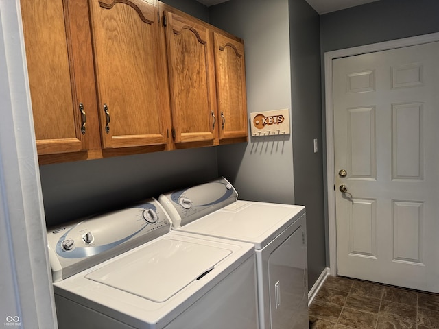 laundry area featuring separate washer and dryer and cabinet space