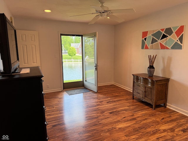 doorway featuring baseboards, dark wood-type flooring, ceiling fan, and recessed lighting