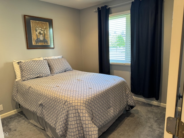 bedroom featuring carpet and baseboards