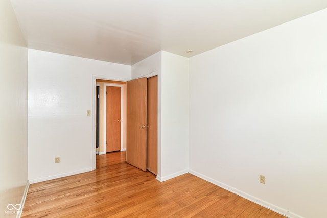 spare room featuring light wood-style flooring and baseboards