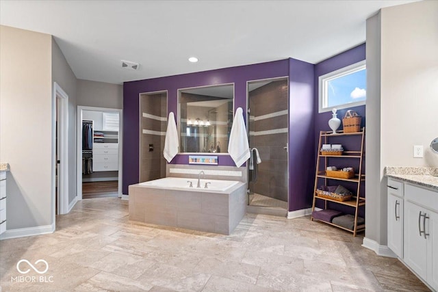 1013 Domino Dr, Carmel, IN 46032 - full bath with vanity, visible vents, a walk in closet, tiled shower, and a bath