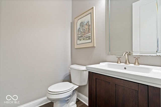 1013 Domino Dr, Carmel, IN 46032 - half bath with baseboards, vanity, toilet, and wood finished floors