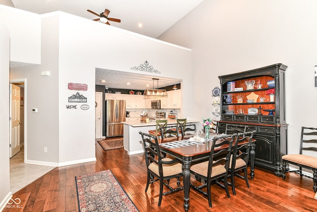12092 Sugar Creek Rd, Noblesville, IN 46060 - dining area featuring ceiling fan, dark wood-style floors, a towering ceiling, baseboards, and recessed lighting