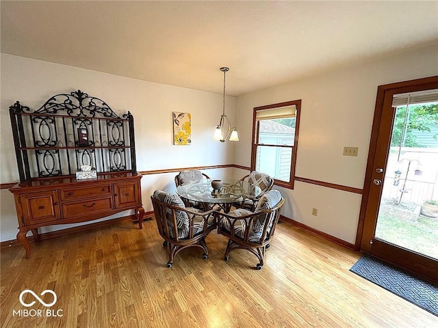 dining area featuring baseboards and wood finished floors