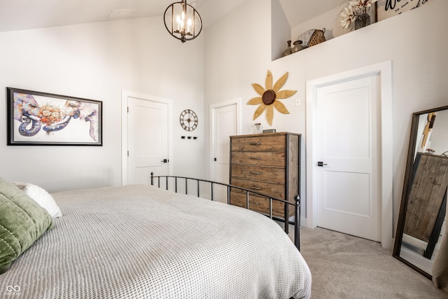 544 N Beville Ave, Indianapolis, IN 46201 - bedroom featuring light carpet, high vaulted ceiling, and a chandelier