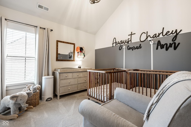 544 N Beville Ave, Indianapolis, IN 46201 - bedroom featuring light carpet, vaulted ceiling, and a crib