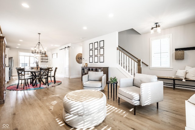 544 N Beville Ave, Indianapolis, IN 46201 - living room with a barn door, light wood-type flooring, stairs, baseboards, and recessed lighting
