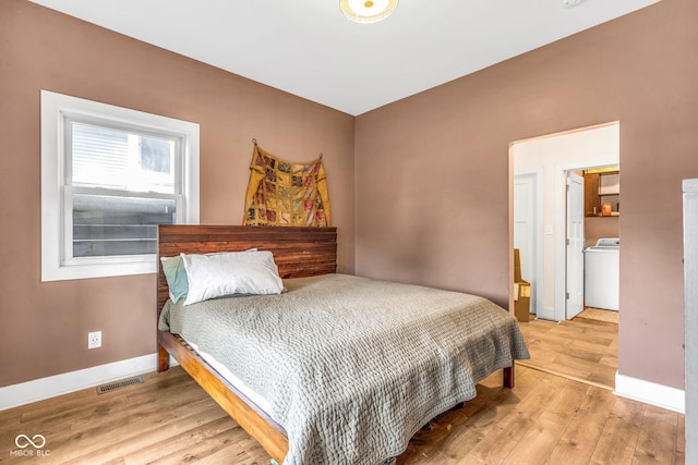 715 Terrace Ave, Indianapolis, IN 46203 - bedroom with washer / clothes dryer and wood finished floors