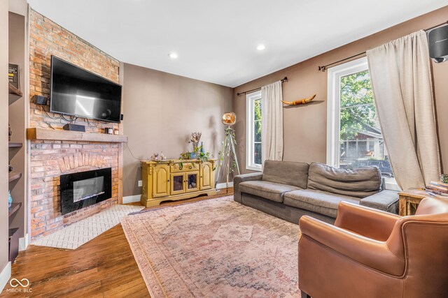 715 Terrace Ave, Indianapolis, IN 46203 - living area with wood finished floors, a brick fireplace, and recessed lighting