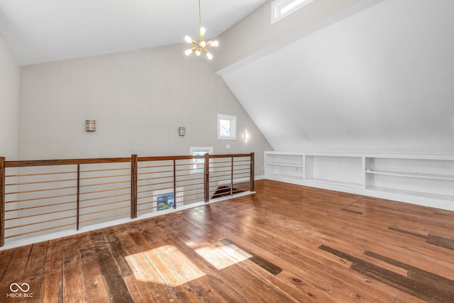 715 Terrace Ave, Indianapolis, IN 46203 - bonus room with hardwood / wood-style flooring, built in shelves, a chandelier, and vaulted ceiling
