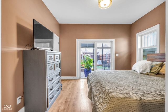 715 Terrace Ave, Indianapolis, IN 46203 - bedroom featuring access to outside and light wood-style flooring
