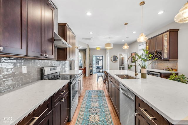 715 Terrace Ave, Indianapolis, IN 46203 - kitchen with appliances with stainless steel finishes, decorative backsplash, recessed lighting, light wood-style floors, and light stone countertops