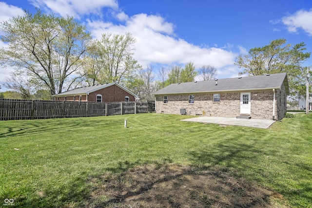 back of property featuring a yard, a patio, and fence