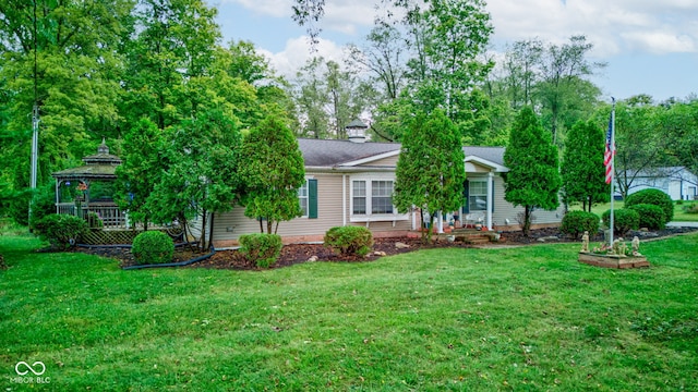 view of front facade featuring a gazebo and a front lawn