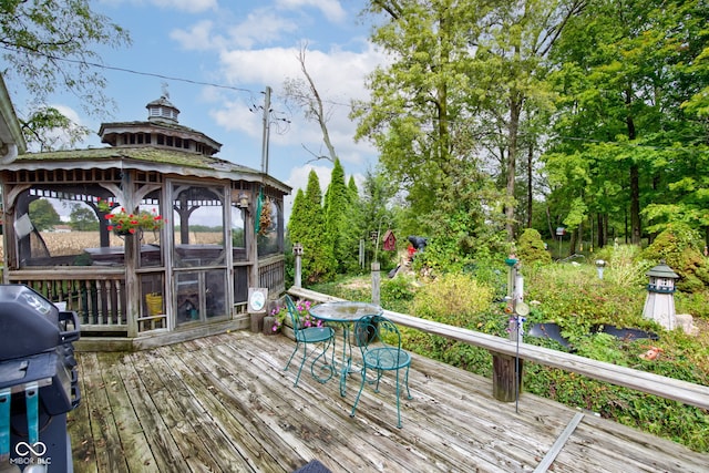 wooden deck with a gazebo and grilling area
