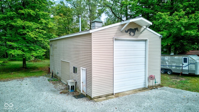 view of outdoor structure featuring an outbuilding and gravel driveway