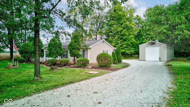 view of front of home featuring an outdoor structure, a garage, a front lawn, and driveway