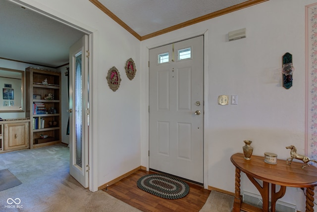 foyer entrance with baseboards and ornamental molding