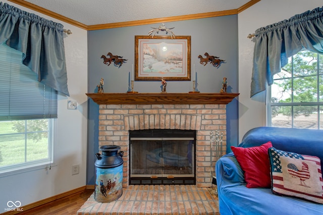 room details featuring a textured ceiling, ornamental molding, a brick fireplace, and wood finished floors