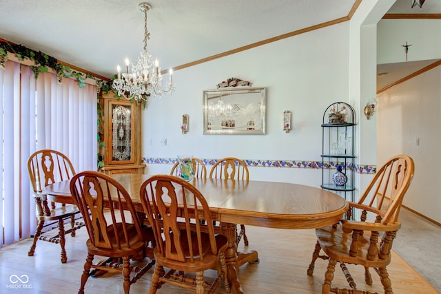 dining room featuring crown molding, baseboards, and a chandelier