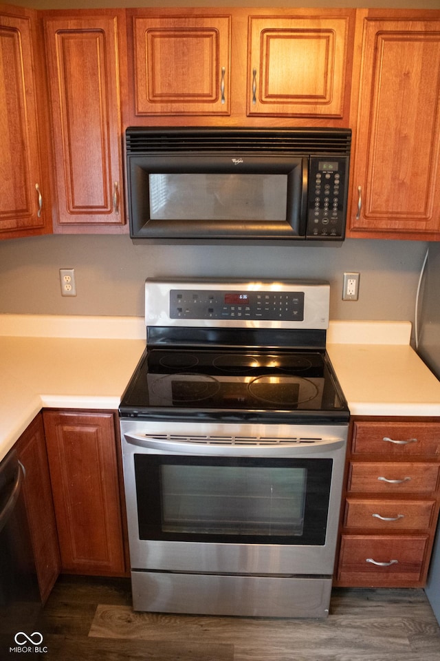 8912 Hosta Way, Indianapolis, IN 46113 - kitchen with stainless steel appliances, brown cabinetry, light countertops, and wood finished floors